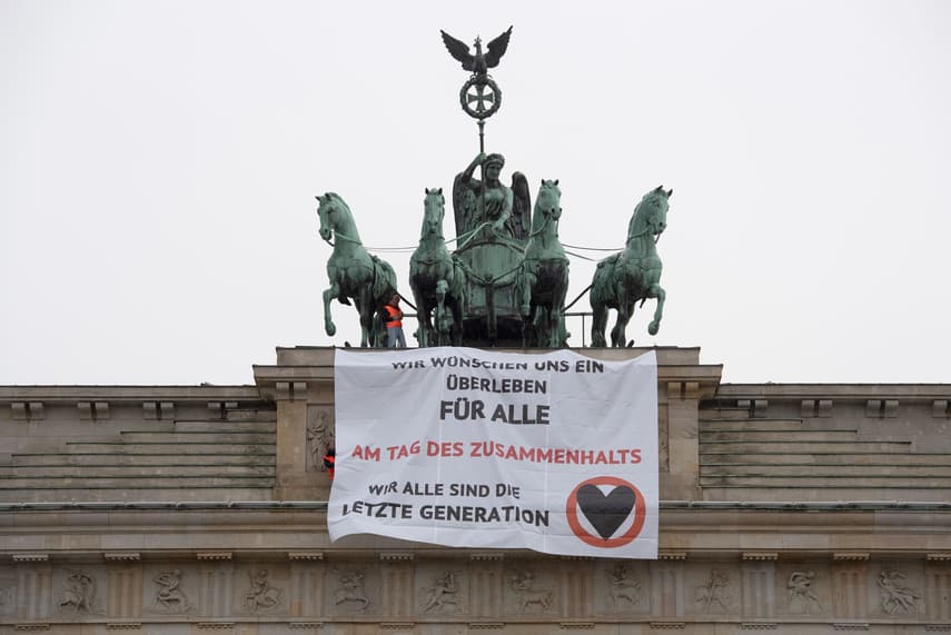 Climate activists scale Berlin’s Brandenburg Gate
