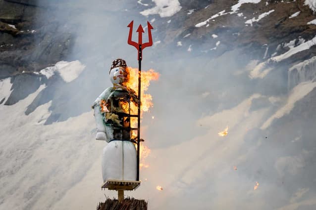 IN PICTURES: Swiss snowman blown up in mountains to herald 'great summer' ahead