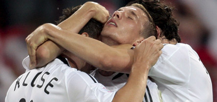 Podolski brace lifts Germany to victory