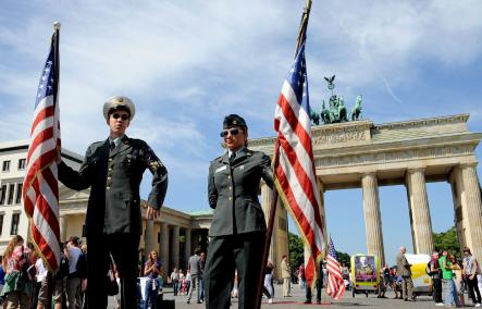 Two actors dressed in military uniforms holding US flags serve as a tourist attraction in front of Brandenburg Gate where Obama is not allowed to speak tonight. Photo: DPA