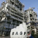 BASF suspends work and cuts profit target