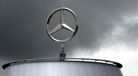 Daimler posts dire loss and cuts wages