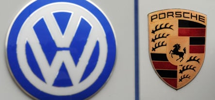 Overstretched Porsche agrees to VW merger