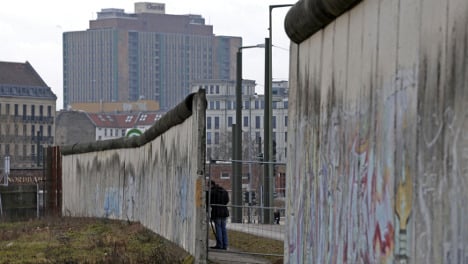 Workers restoring watchtower to stretch of Berlin Wall
