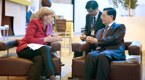 Merkel vows to prod China over human rights