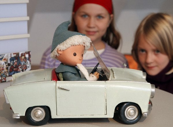 Fans Jessica and Mae check out the Sandman, an East German creation, in his Trabant. Photo: DPA