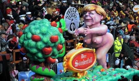 Karneval floats feature giant Obama, naked Merkel and zombie bankers