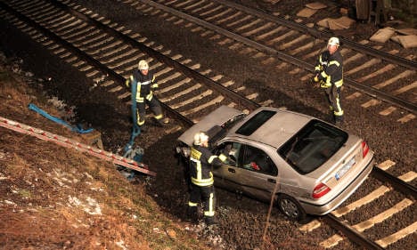Car falls from bridge onto train tracks in deadly accident