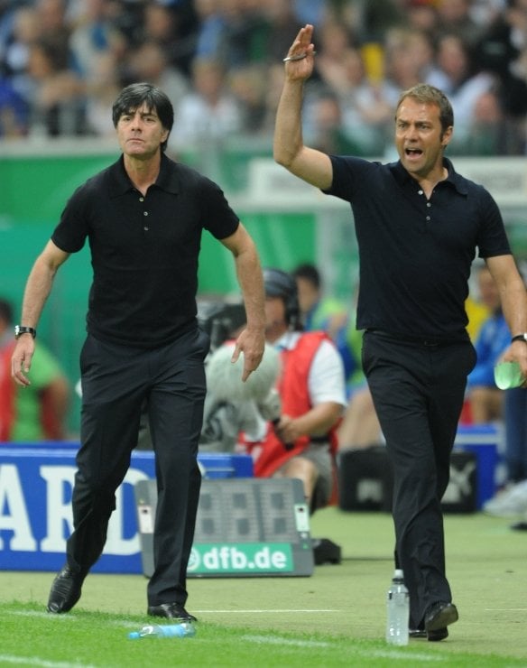 Joachim Löw and Hans-Dieter Flick<br>Coaches Joachim Löw and Hans-Dieter Flick on the sidelines. Löw has an extensive coaching history and has secured a place in the hearts of the German people by turning the German game from a static defensive style to a more exciting and fast-paced attacking style which has proven far more successful. The 50-year-old didn't have the most illustrious footballing career as a player, but his technical understanding and meticulous game planning and analysis have mPhoto: DPA
