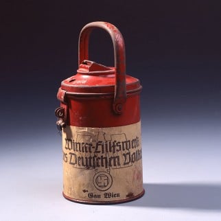 A collection tin for the <i>Winterhilfswerk</i>, an annual drive by the <i>Nationalsozialistische Volkswohlfahrt</i> (the National Socialist People’s Welfare Organization) to collect money for food and coal for poorer families during the winter months. Photo: Arne Psille/Deutsches Historisches Museum