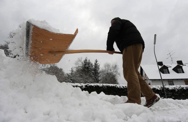 A man shovels snow from his front stoop in Starnberg, Upper Bavaria. Photo: DPA