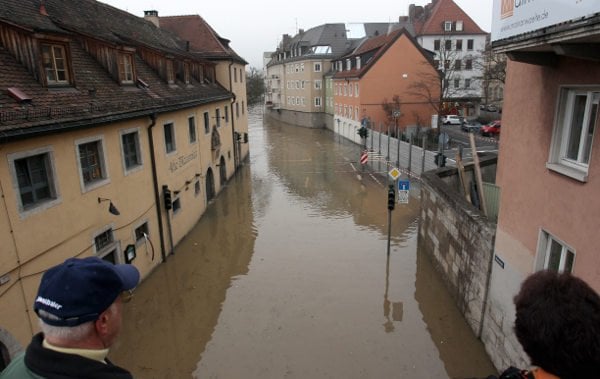 Residents survey floodwaters in Würzburg, in the Bavarian district of Lower Franconia.Photo: DPA