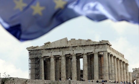 Merkel and Sarkozy back Greece as worries mount