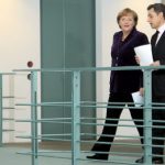 Merkel, Sarkozy vow to solve eurozone crisis