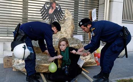 Protesters drop golden turd by Athens embassy