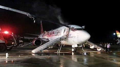Three hurt in scramble off smoke-filled plane