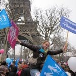 A protestor at the Eiffel Tower holds signs saying "Everyone born to a man and a woman" and "Difference is the key to existence."Photo: Dan Mac Guill/The Local
