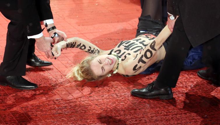 An activist from FEMEN Germany storms the red carpet to protest against female genital mutilationPhoto: DPA