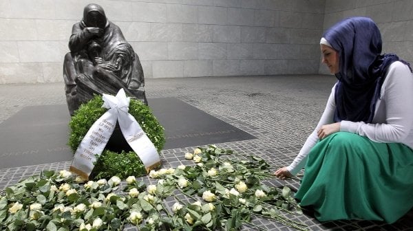 Mother and her Dead Son: the statue of a grieving woman holding the body of her dead son, created by the sculptor Käthe Kollwitz and housed in the <i>Neue Wache</i> on Berlin's Unter den Linden. The 1818 building has always been used by different governments to commemorate the dead of war, and after German reunification Kollwitz's statue was installed as an expression of that loss. Here flowers are laid to mark the Srebrenica massacre.Photo: DPA
