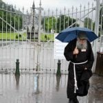 A priest walks near closed door of a sanctuary on June 18, 2013 after the Gave de Pau, the river passing through Lourdes, southwestern France, floods some sites of the town.Photo: Pascal Pavani/AFP