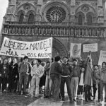 December 25th, 1985. Members of 'SOS Racisme' and the French anti-apartheid movement, including current Socialist party chairman Harlem Désir, gather in front of Notre Dame cathedral in Paris for a Christmas Day rally.
Their banners read "No to apartheid" and "Free Mandela."Photo: Michel Clement