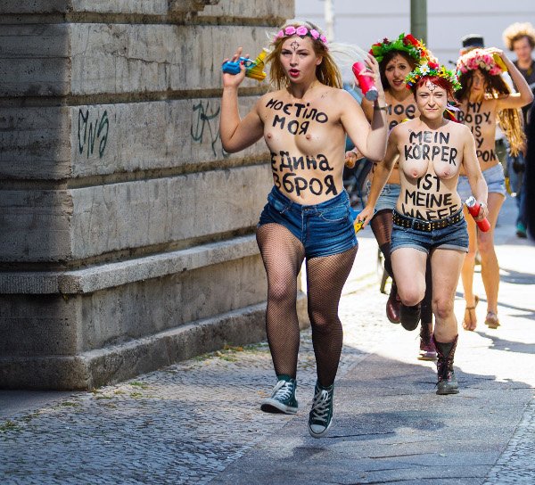 Topless protesters run towards the Ukrainian embassy in Berlin to demonstrate at the crackdown of feminist group Femen in the Ukraine.Photo: DPA