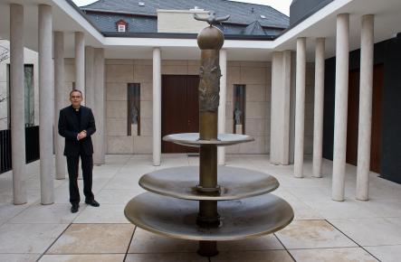 The bishop by a courtyard fountain in the newly renovated residence.Photo: DPA