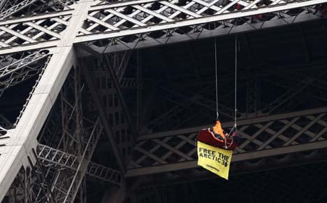 Greenpeace activist protests on Eiffel Tower