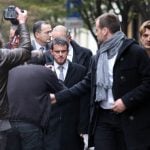 Interior Minister Manuel Valls arrives at the offices of Liberation to view the scene after the first shooting on Monday.Photo: AFP