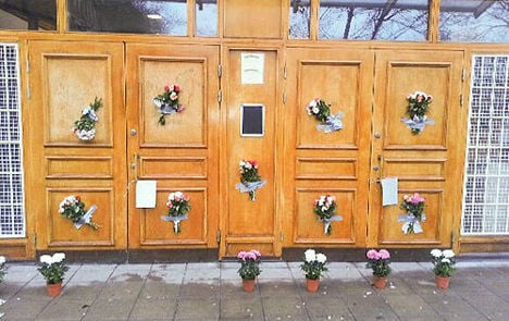 Flowers cover swastikas after mosque attack