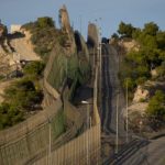 Desperate migrants storm fences in Melilla