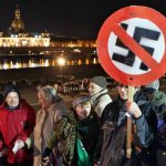 Protesters hold up placards with a line drawn through the image of a swastika as they successfully campaigned to keep neo-Nazis away from the Dresden memorial.Photo: DPA