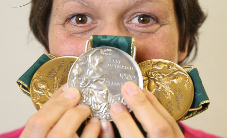 Swimming champion auctions Olympic medals