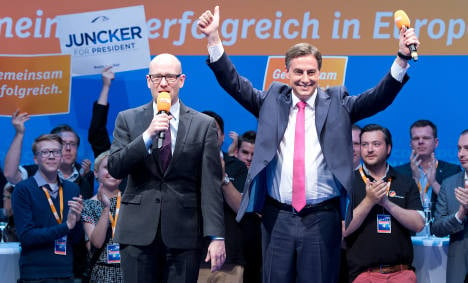 Merkel's party tops vote but loses ground