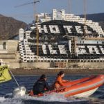 Greenpeace paints hotel black in coast demo