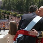 Felipe receives a kiss from kiss from his father Don Juan Carlos as thousands cheer them from Madrid's royal gardens. Photo: Javier Lizon/AFP