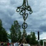 Raising the Maypole is a gradual process of slowly moving other long poles towards the base to prop the Maypole into position.Photo: The Local/Solveig Rundquist