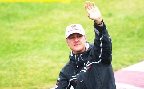 Out of coma Schumacher taken to Swiss hospital