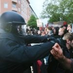 "National Socialism is No Alternative" protesters stand opposite heavily armed police. Security was tightened before the event to cope with protests and any potential threats.Photo: DPA