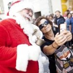 A tourist snaps a selfie with Santa.Photo: David Leth Williams/Scanpix
