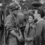 A French soldier of the Leclerc Division is shown discussing with young Parisians on August 25, 1944 during the military parade marking the Liberation of Paris during World War II.Photo: AFP