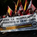 Anti-independence Catalans hold Spanish flags and a banner reading "against separatist manipulation of history" as they take part in a demonstration for the unity of Spain Photo: Josep Lago/AFP