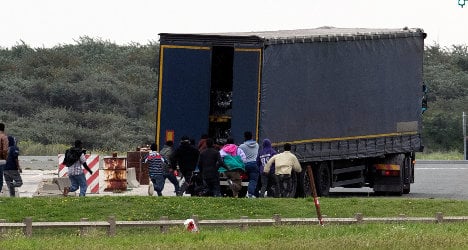 UK-bound migrants rush aboard trucks in Calais
