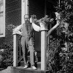 The photographer himself, Einar Erici, on the doorsteps of a house. We don't know where this is or who took the photo but we've glad they did. 