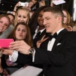 Some lucky young fans get a picture with dapper football <i>Weltmeister</i> Bastian Schweinsteiger on the red carpet. Photo: DPA