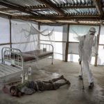 3rd place, News Photo (International). At an Ebola clinic in Bomi, Liberia, the body of David Sakei 50, is sprayed with chlorine. He will soon be buried without relatives at an Ebola victims gravesite.Photo: Niclas Hammarström (Aftonbladet, Kontinent)/Årets Bild 