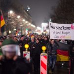 Pegida supporters in Berlin demonstrate with the Brandenburg Gate behind them. A few hundred 'Bärgida' proponents went to the streets on Monday night while 4,000 people protested against them.Photo: DPA