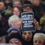 A woman holds a sign that reads 'We are Charlie, we are not Pegida' during a protest in Düsseldorf.Photo: DPA