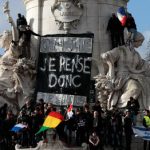 A sign that reads "I think therefore I am" is hung at the Place de la Republique as people gather with their national flags.Photo: Joel Saget/AFP