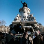 People start gathering at the statue of Marianne at the Place de la Republique on Sunday morning prior to a huge march which will end at the Place de la Nation. Photo: Joel Saget/AFP